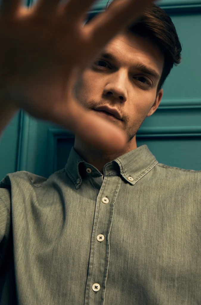 Nikola casual editorial fotoğrafı, denim gömlekli erkek model, el bloklama efektiyle yaratıcı portre, Paulmark için Ankara moda fotoğrafçısı Şems Erik