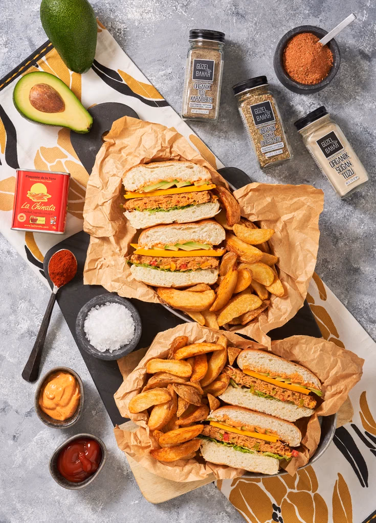 MacroStyle gastronomi fotoğrafı, sandviç ve patates dilimleri, baharat şişeleri ve avokado ile kurulmuş üstten çekim, Ankara yemek fotoğrafçısı Şems Erik